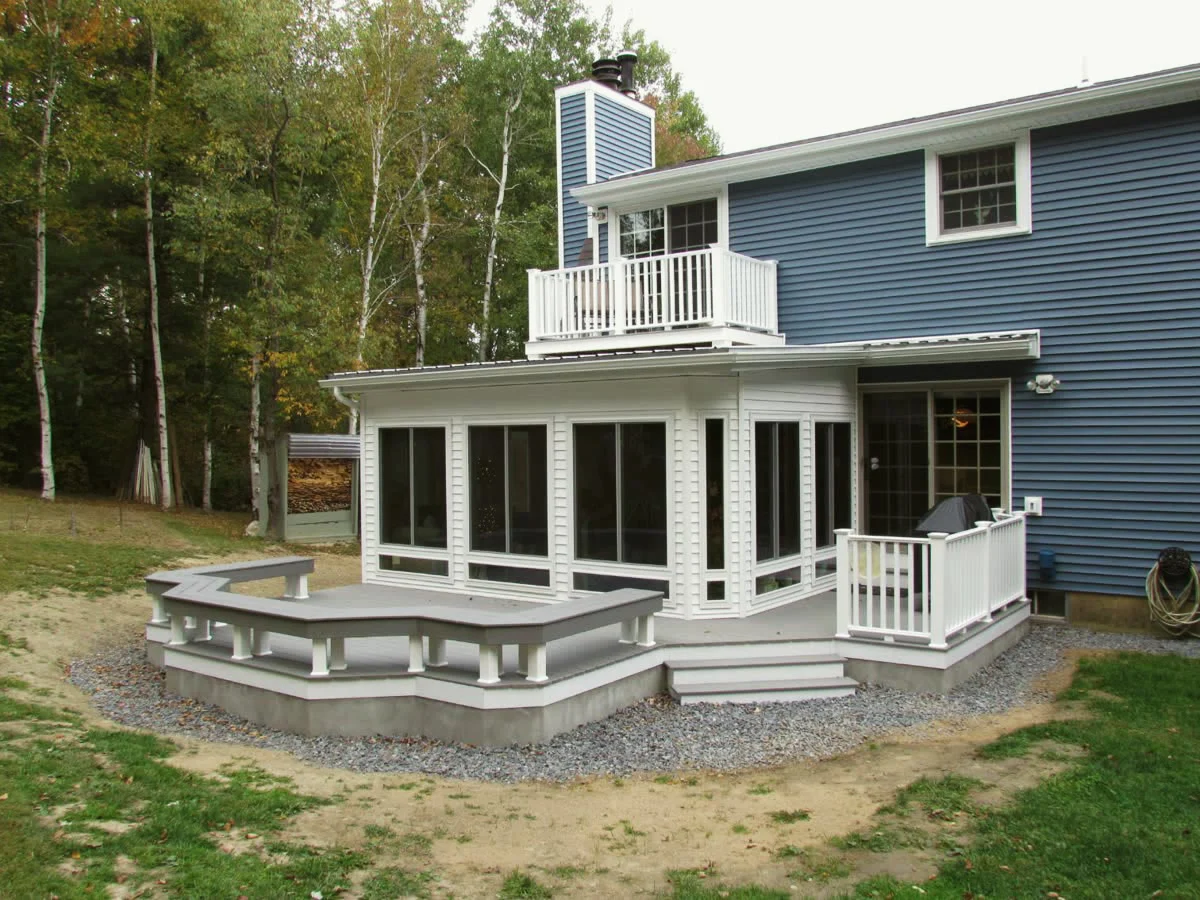 Screenroom addition with balcony above and a wraparound composite deck